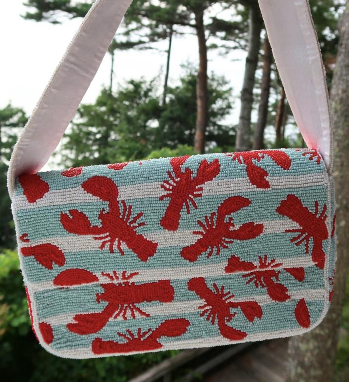 Lobster beaded shoulder bag with detailed red lobster design and structured silhouette