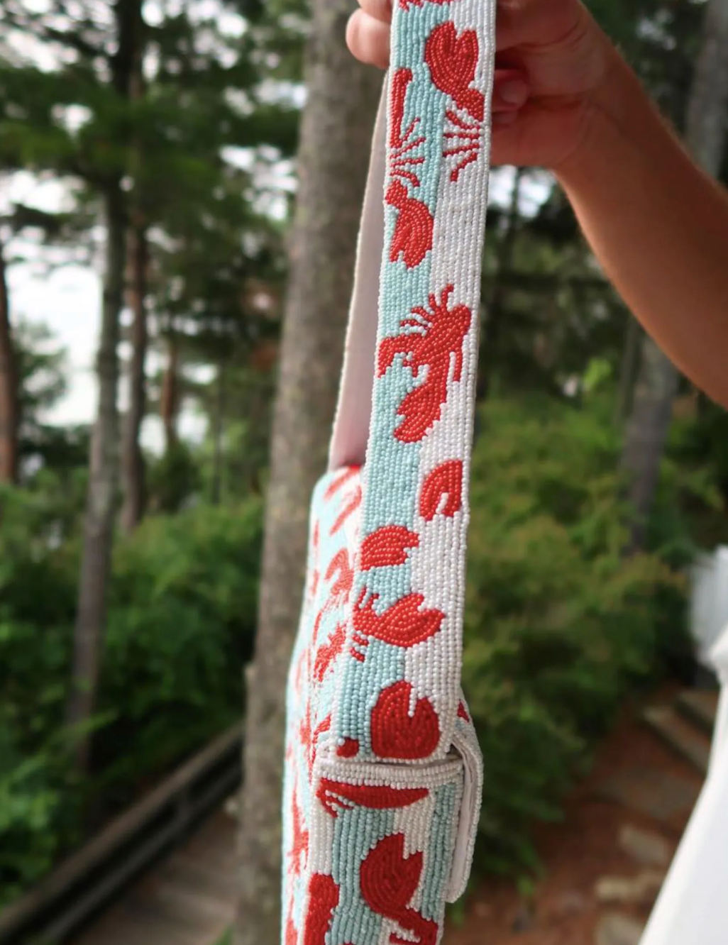Lobster beaded shoulder bag with detailed red lobster design and structured silhouette