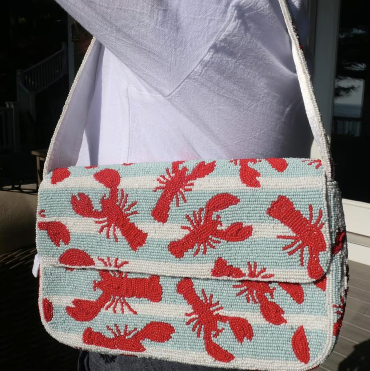 Lobster beaded shoulder bag with detailed red lobster design and structured silhouette